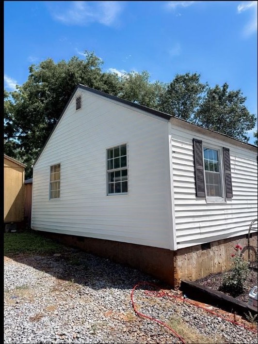 After — Soft washing a home's siding — green algae lifted to clean