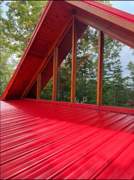 Roof soft wash in Athens, TN — faded red metal roof restored to clean